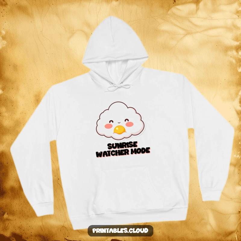 Funny hoodie depicting a rosy-cheeked cloud character gazing at a tiny sun rising, radiating warmth and gentle happiness.